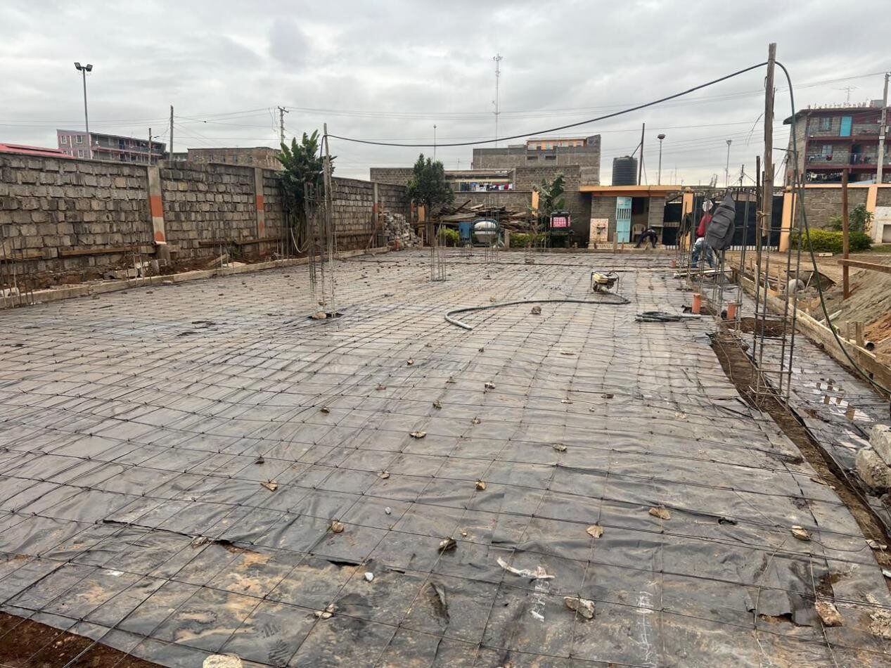 Reinforcement mesh laid over damp-proof membrane before slab casting