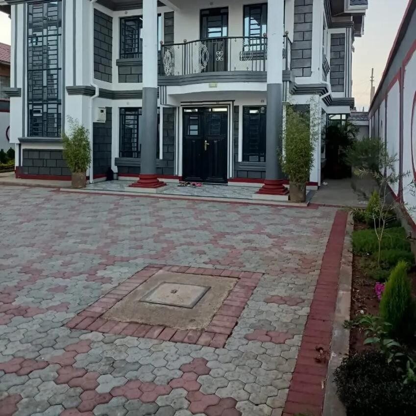Ground floor entrance and paved driveway of the Kamulu Gardens residence
