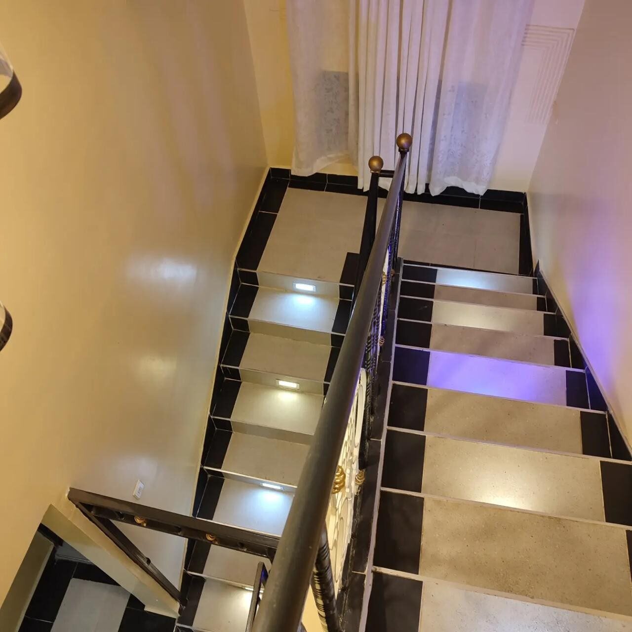 Internal staircase with feature lighting inside the Kamulu Gardens home