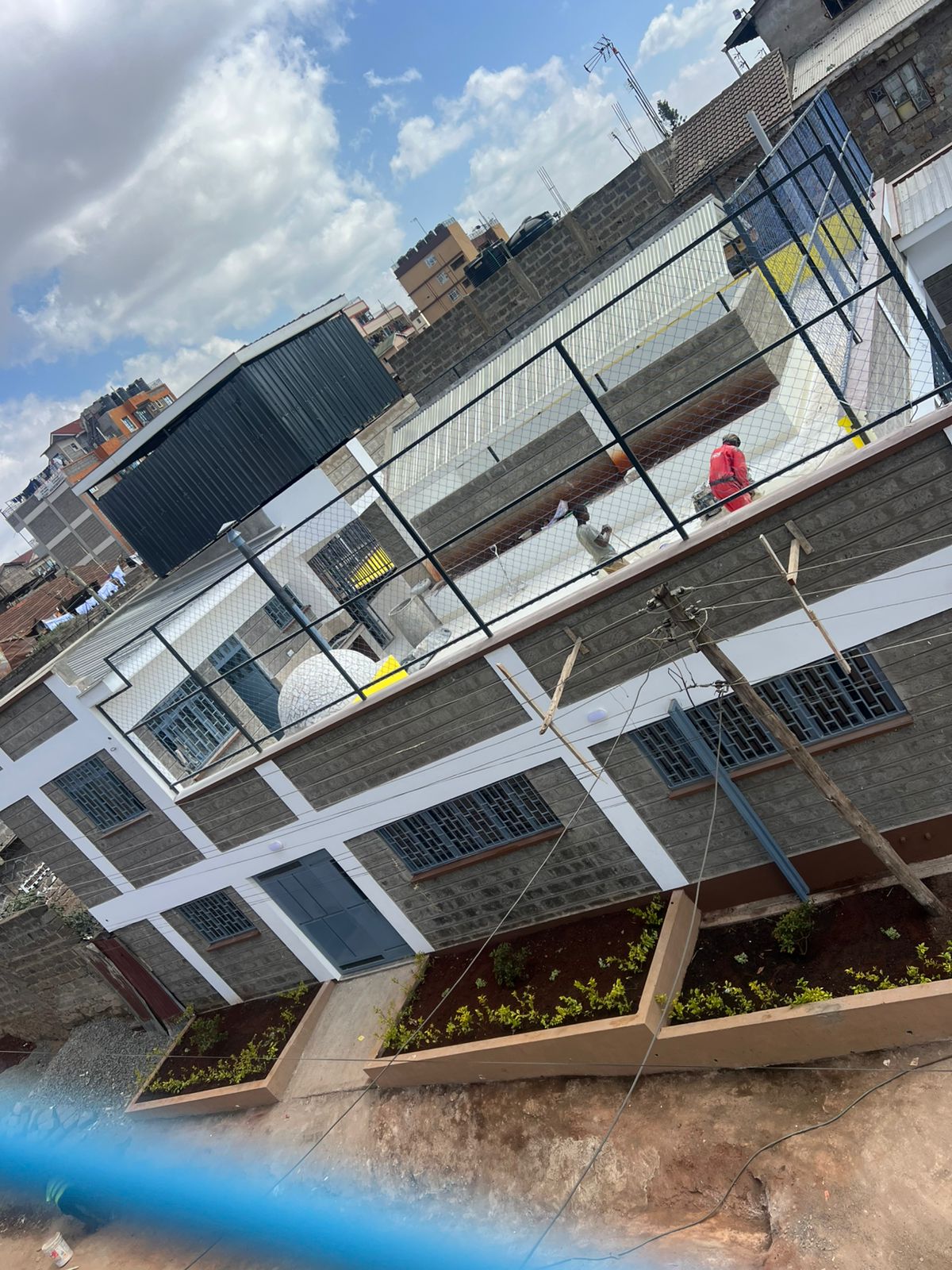 Rooftop play area and stone facade of the Smiling Centre in Lucky Summer, Nairobi