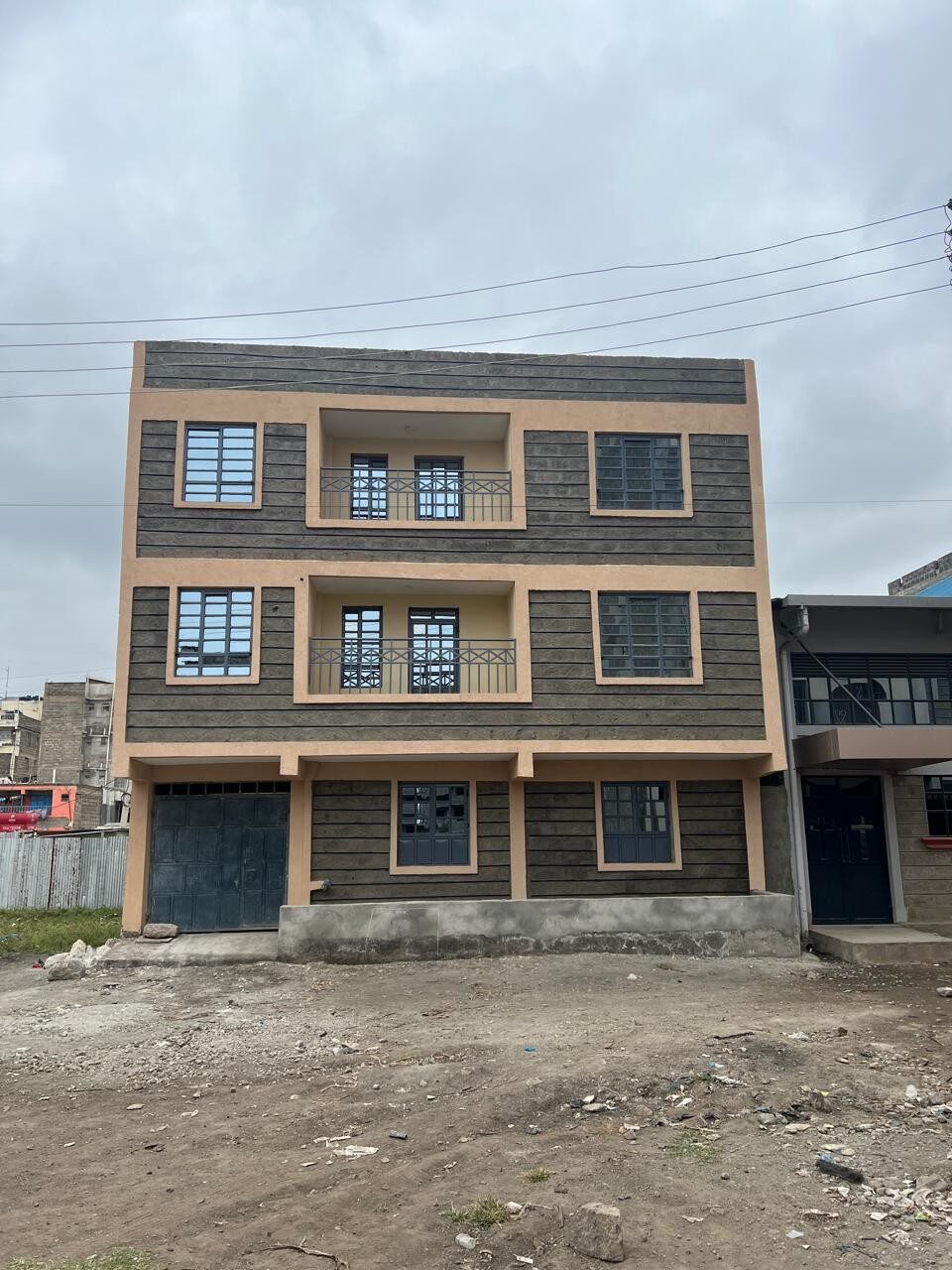 Stone-textured facade and balconies of the Umoja apartment block